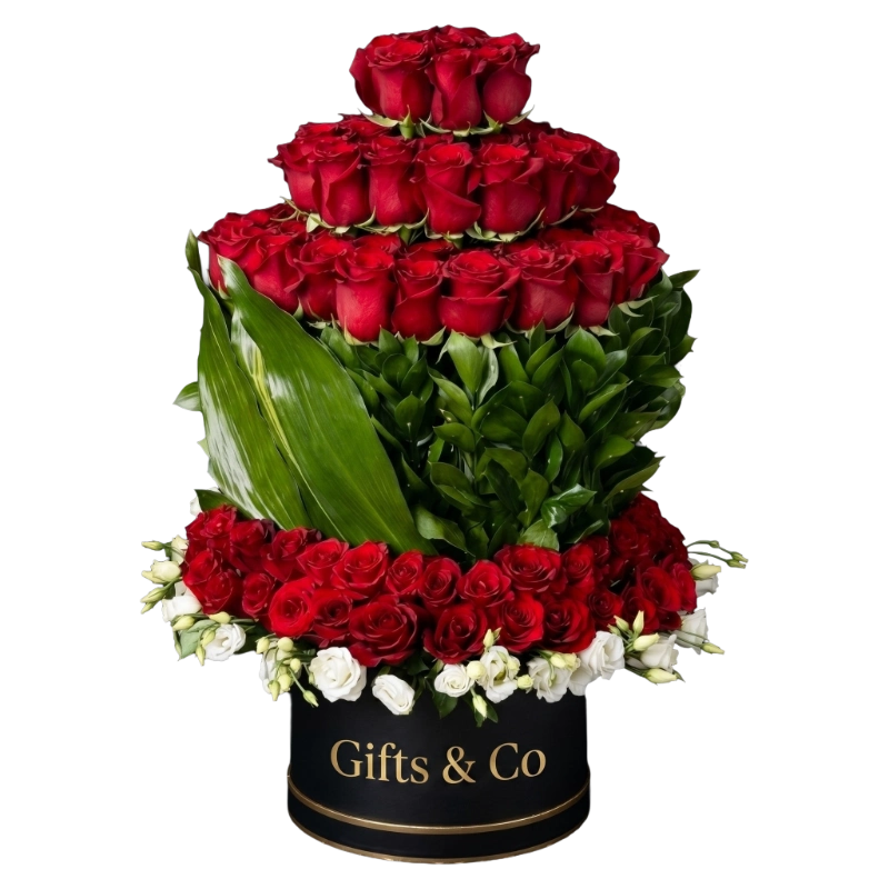 Luxury Red Rose Tower Box featuring premium red roses, white spray roses, seasonal foliage, and a signature Gifts & Co keepsake flower box.