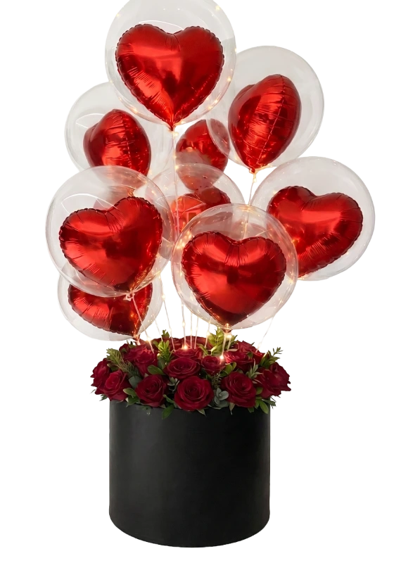 The Eternal Love Balloon Rose Box featuring premium red roses, floating metallic heart balloons inside transparent bubble balloons, warm fairy lights and a luxury black hat box by Gifts & Co.