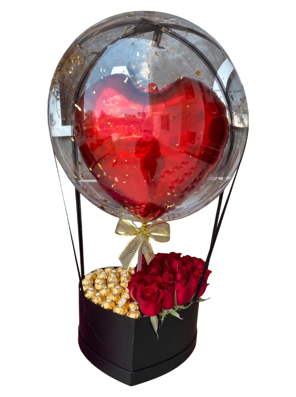 The Golden Heart Luxury Rose & Chocolate Balloon Box featuring premium red roses, Ferrero Rocher chocolates, a floating metallic heart balloon inside a transparent bubble balloon, and a heart-shaped luxury gift box by Gifts & Co.